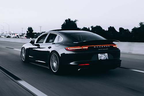 sports car running black Porsche sedan automobile